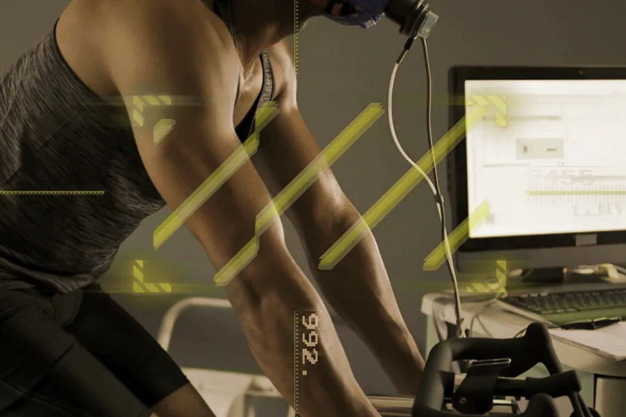 A man with a breath analysis device on a stationary bike. Schedule PNOE metabolic analysis testing from Shelley Cole, M.D. of Healthy Success in Temple, Texas.