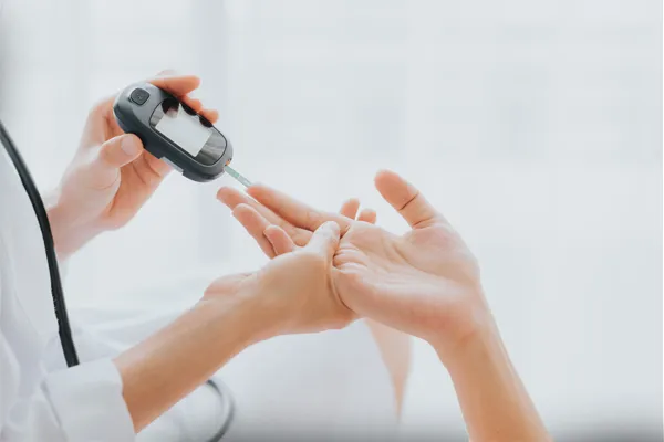 Close up of a medical professional testing a patient's blood sugar levels. Get treatment for Type 1 Diabetes from Shelley Cole, M.D. of Healthy Success in Temple, Texas.